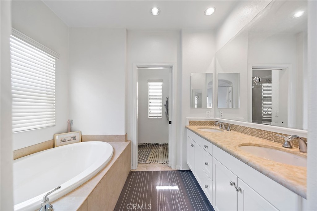 876 Sunset Place Diamond Bar, CA 91765 - Photo 10 of 17 a spacious bathroom with a granite countertop tub sink shower and mirror