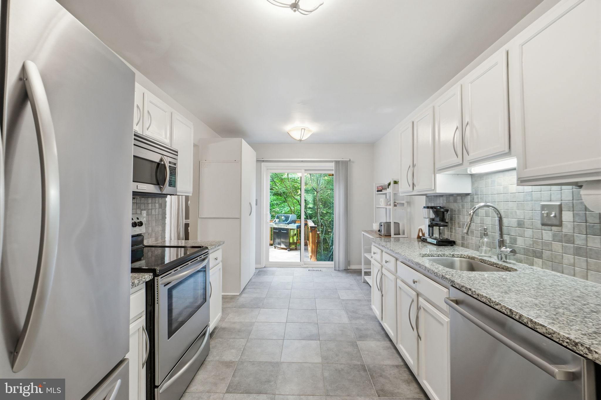 7660 Southern Oak Drive Springfield, VA 22153 - Photo 14 of 37 KITCHEN LEADING ONTO PRIVATE DECK