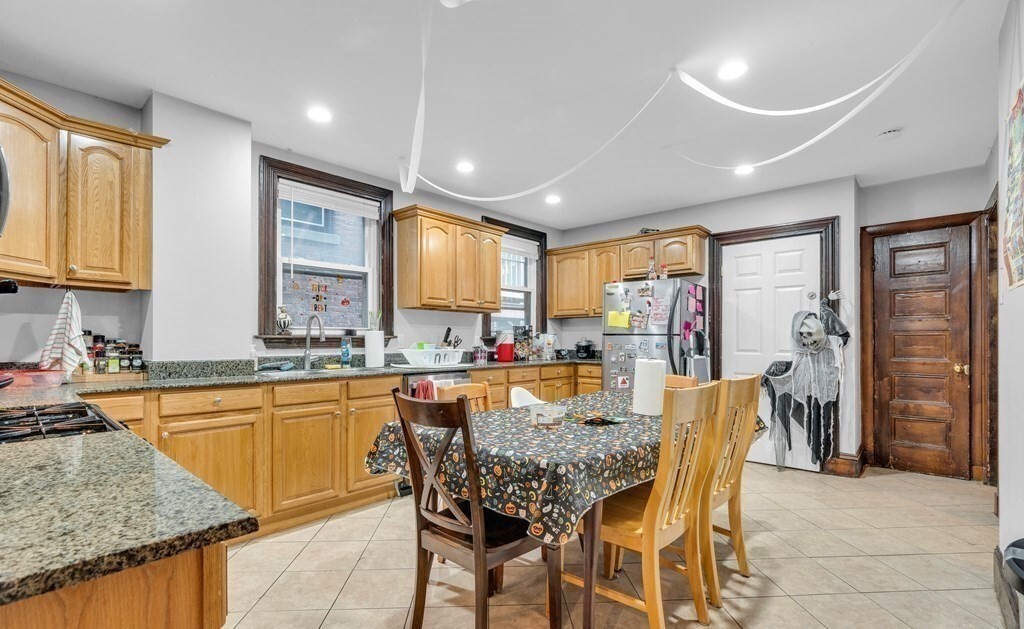 a view of a dining room with furniture and a kitchen