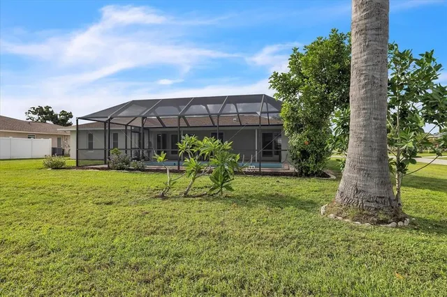 an aerial view of a house with a garden and houses