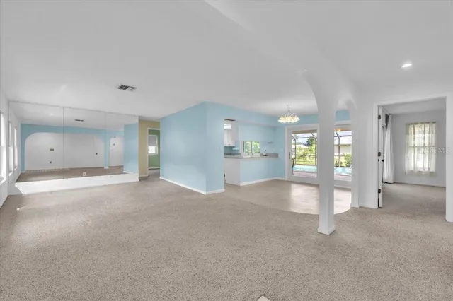 a view of a big room with closet and windows