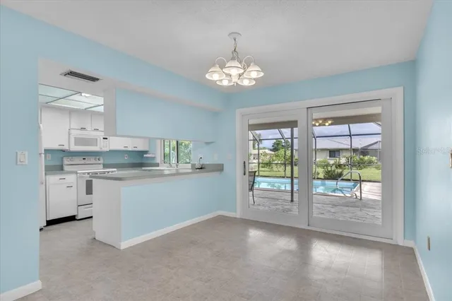 a open kitchen with granite countertop a stove top oven a sink and dishwasher