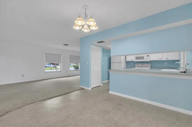 a kitchen with cabinets appliances a sink and a window