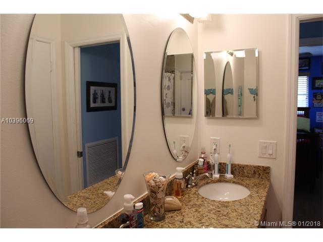461 Northeast 42nd Street Boca Raton, FL 33431 - Photo 11 of 14 a bathroom with mirror sink and vanity
