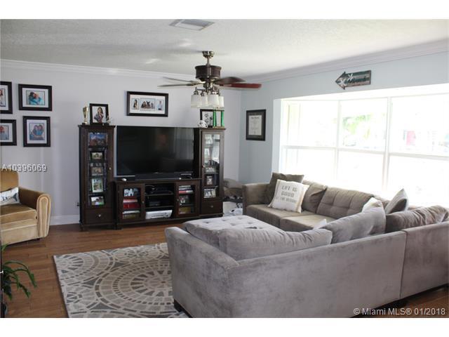 461 Northeast 42nd Street Boca Raton, FL 33431 - Photo 2 of 14 a living room with furniture and a flat screen tv