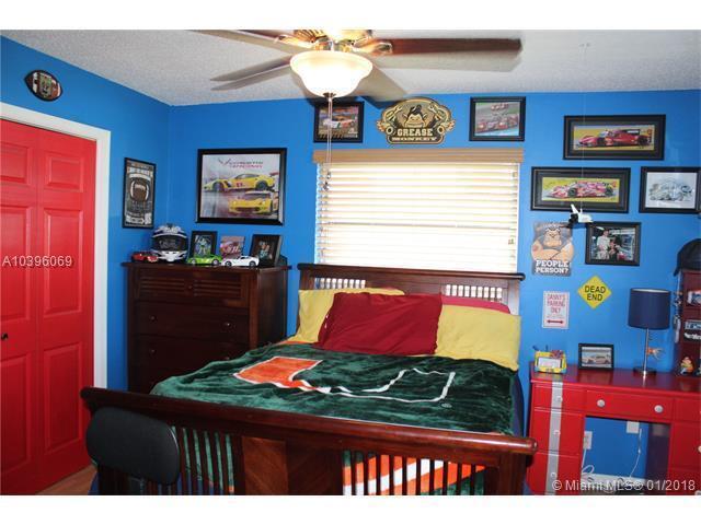 461 Northeast 42nd Street Boca Raton, FL 33431 - Photo 9 of 14 a bedroom with a bed window and wall paintings