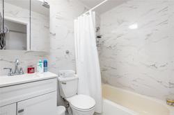 86-20 57th Road Queens, NY 11373 - Photo 11 of 21 Bathroom with toilet, shower / bath combo with shower curtain, and vanity