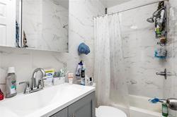 86-20 57th Road Queens, NY 11373 - Photo 7 of 21 Bathroom featuring toilet, vanity, and shower / tub combo with curtain