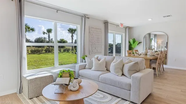 a living room with furniture and a large window