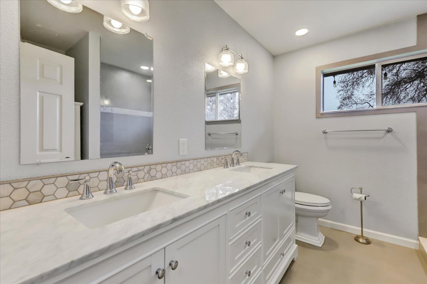 19310 John Born Road Penn Valley, CA 95946 - Photo 13 of 78 a bathroom with a granite countertop sink mirror and toilet
