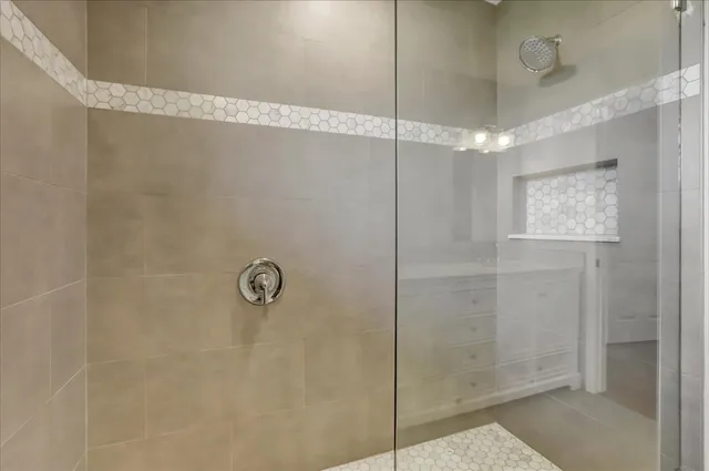 a view of a kitchen with white cabinets and window
