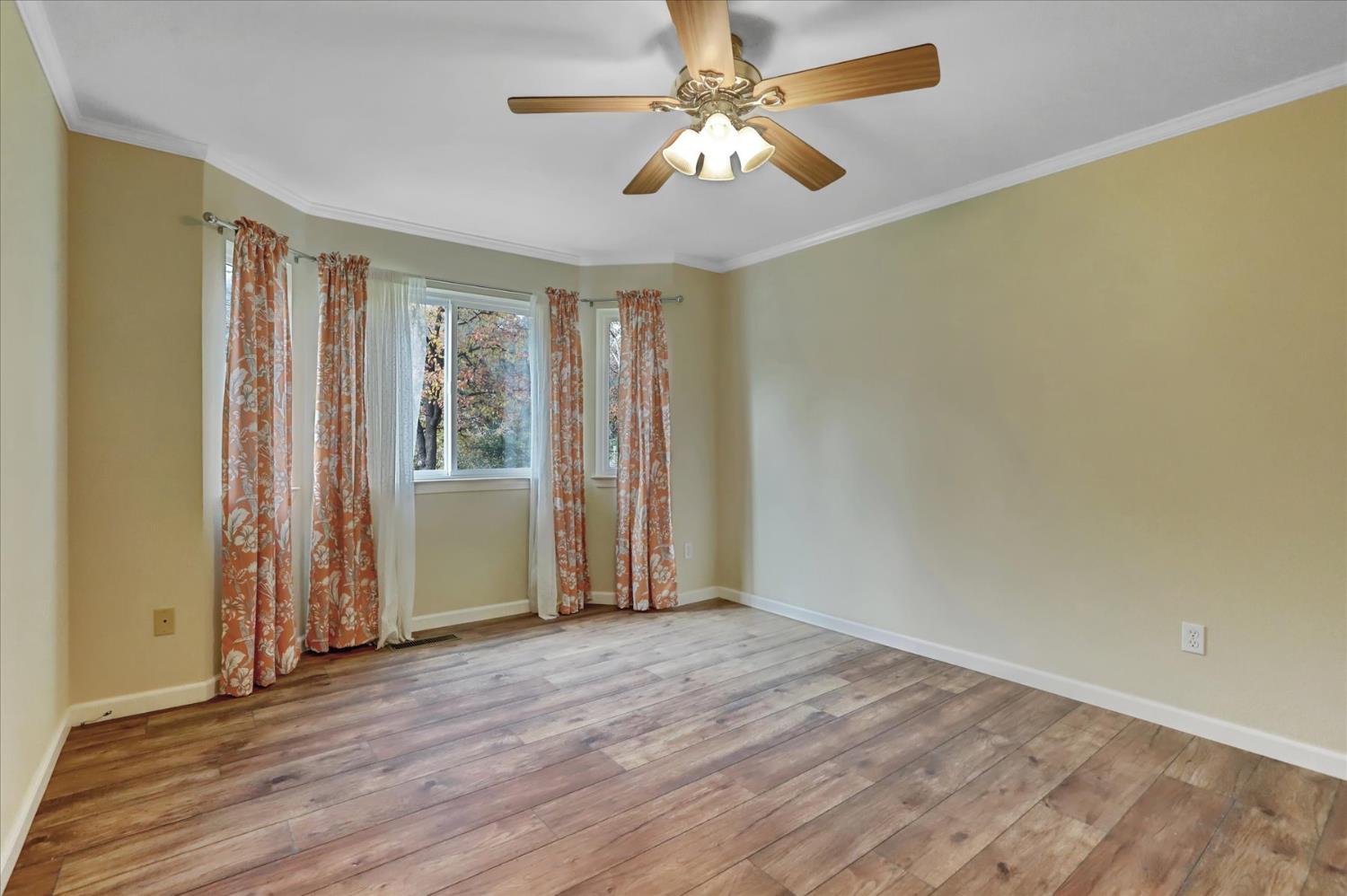 19310 John Born Road Penn Valley, CA 95946 - Photo 19 of 78 an empty room with wooden floor fan and windows