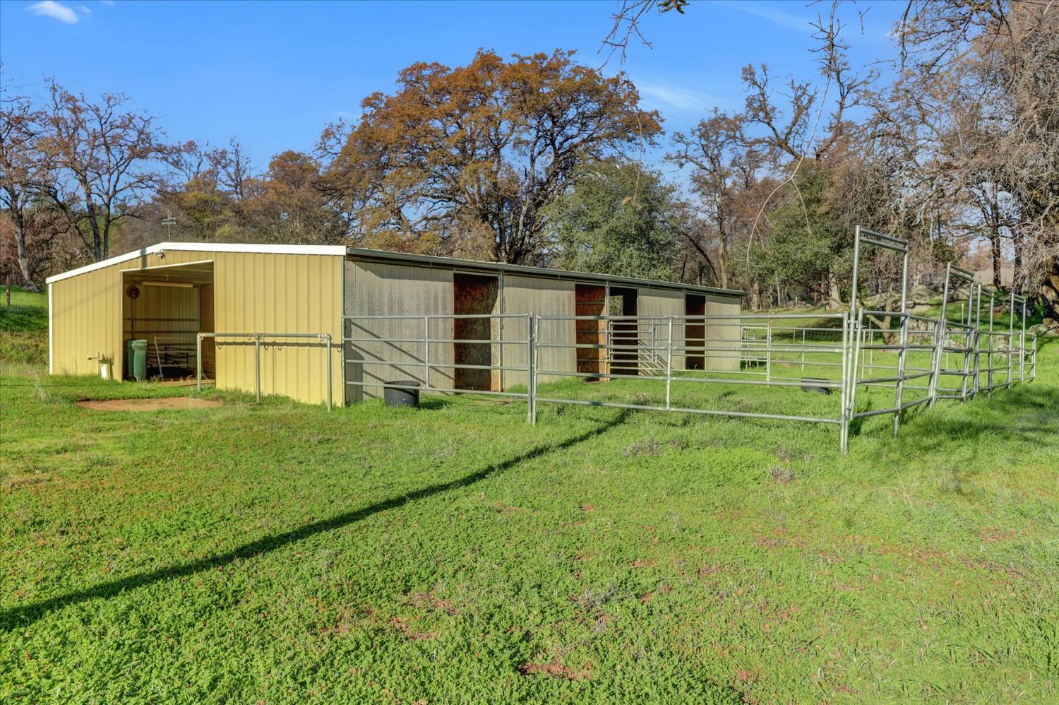 19310 John Born Road Penn Valley, CA 95946 - Photo 39 of 78 a backyard of a house with wooden fence and large trees