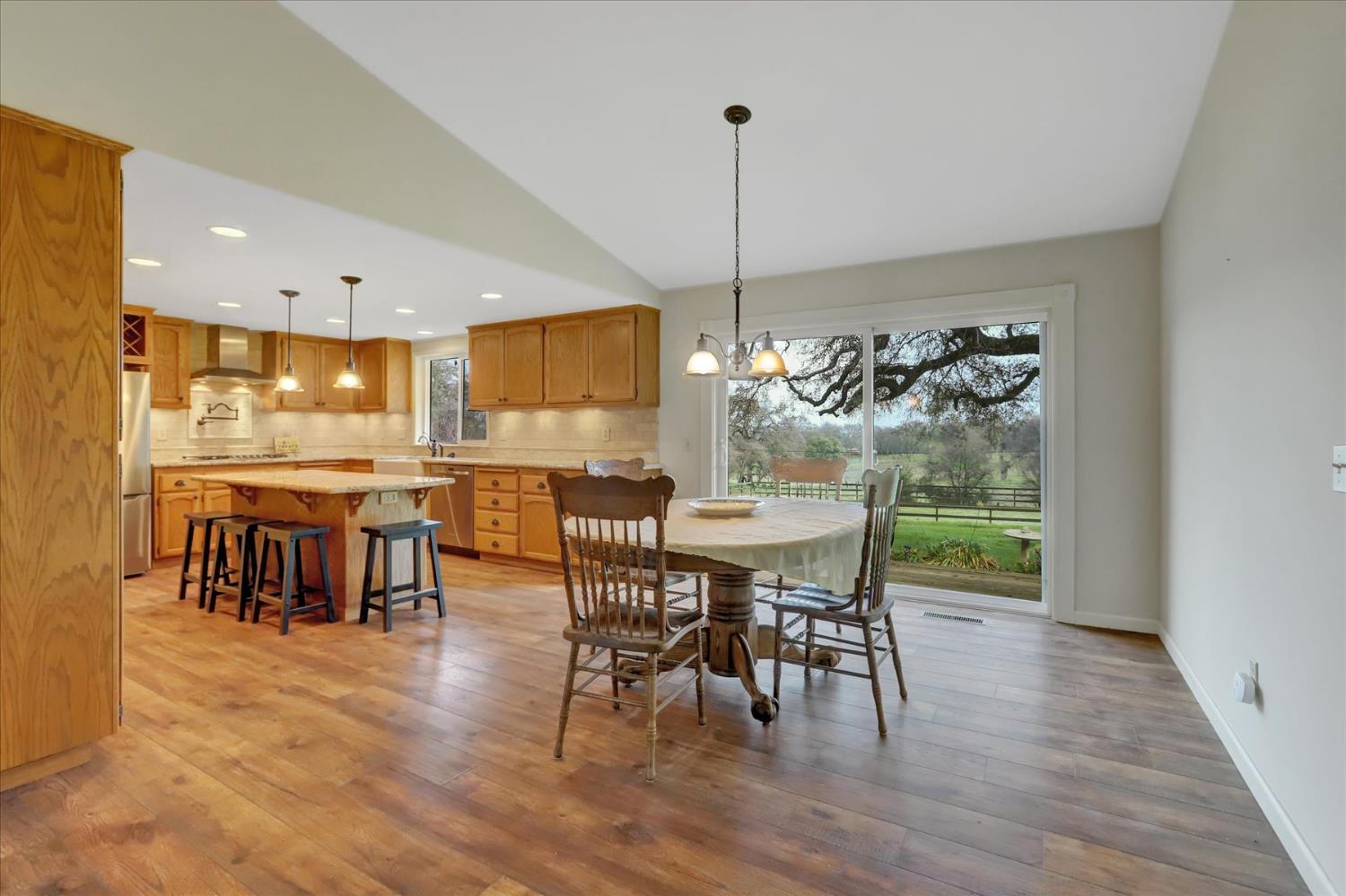 19310 John Born Road Penn Valley, CA 95946 - Photo 4 of 78 a view of a dining room and livingroom with furniture wooden floor a chandelier