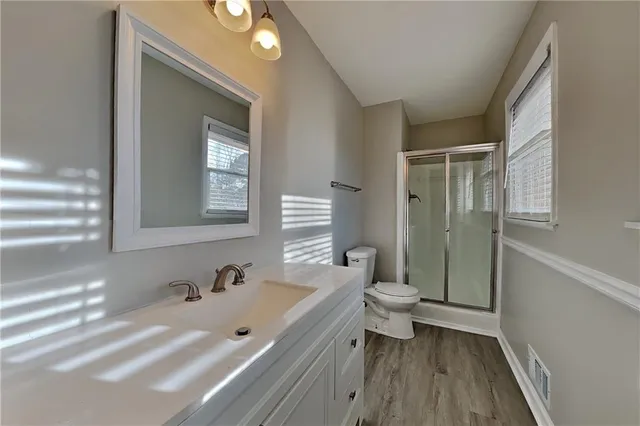a bathroom with a double vanity sink toilet and shower