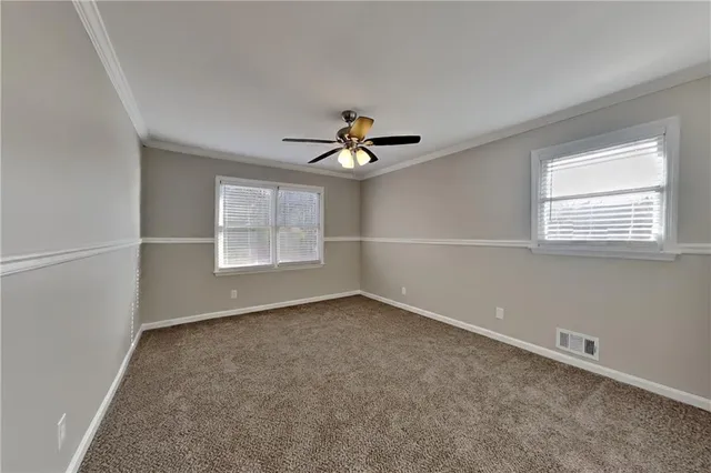 a view of a livingroom with a ceiling fan and window