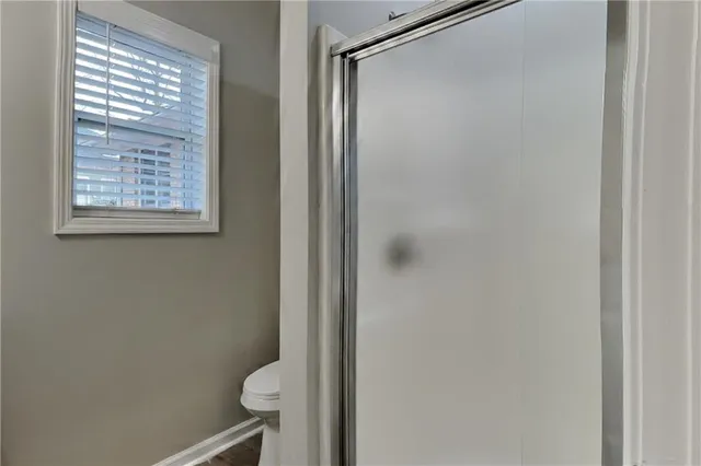 a bathroom with a shower and toilet