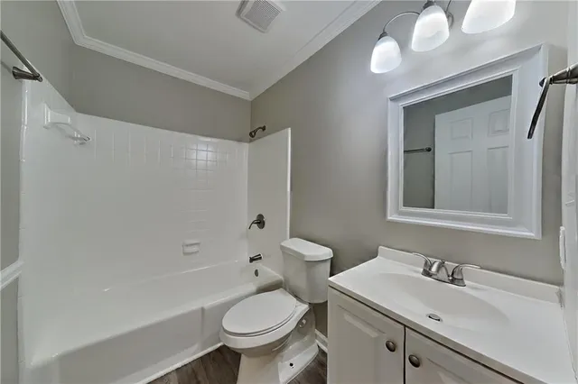a bathroom with a sink toilet vanity and shower