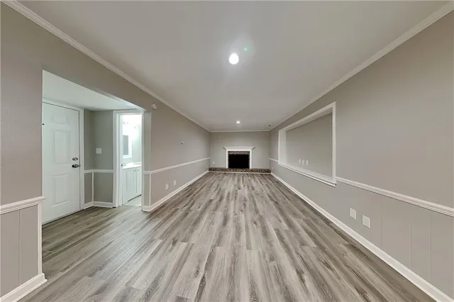 a view of a room with wooden floor and a window