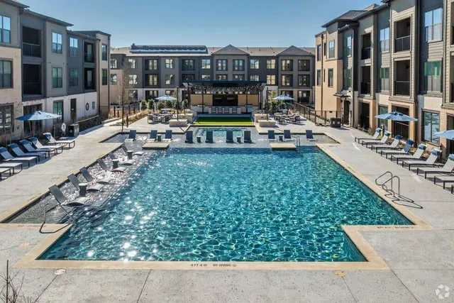 a view of swimming pool with outdoor seating and a garden