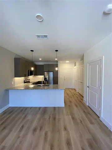 a view of a living room and kitchen