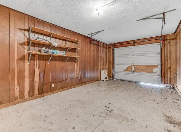 a view of an empty room with wooden walls