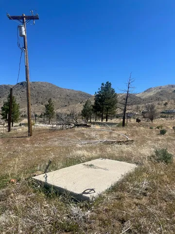 a view of a dry yard with a mountain