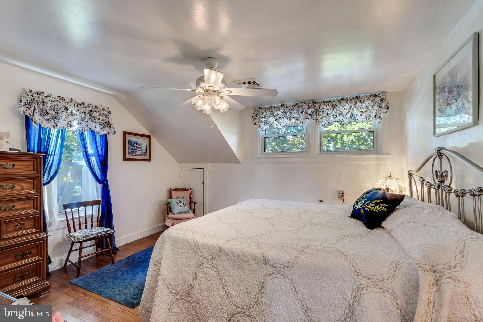 213 Garnet Street Carneys Point, NJ 08069 - Photo 14 of 39 a bedroom with a bed a chandelier and a book shelf