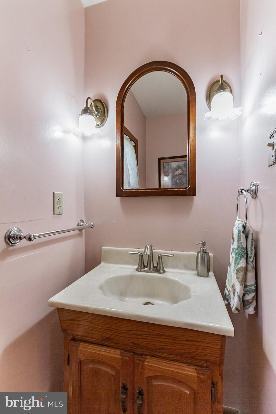 213 Garnet Street Carneys Point, NJ 08069 - Photo 21 of 39 a bathroom with a sink and mirror