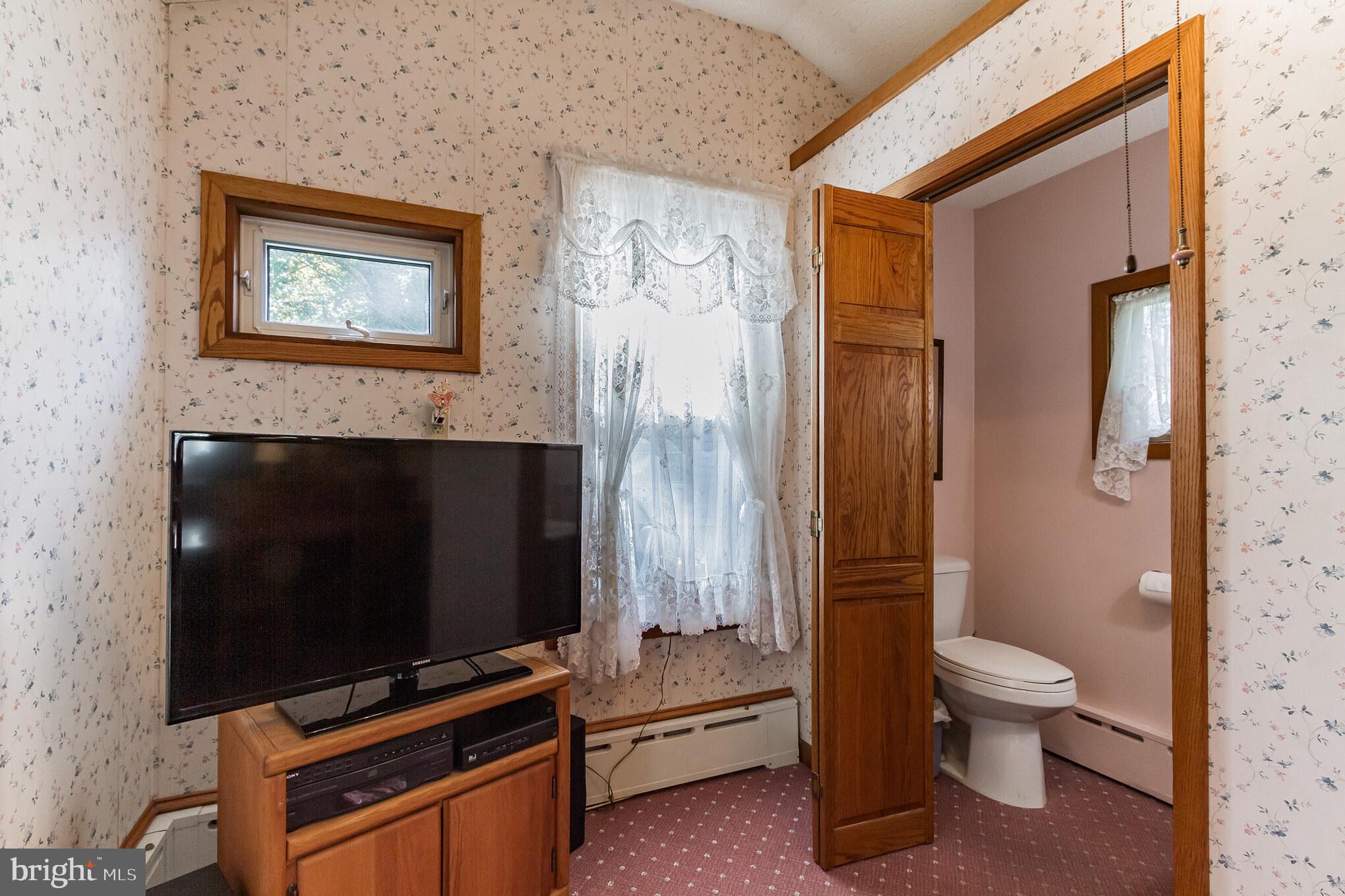 213 Garnet Street Carneys Point, NJ 08069 - Photo 22 of 39 a living room with a flat screen tv and a fireplace