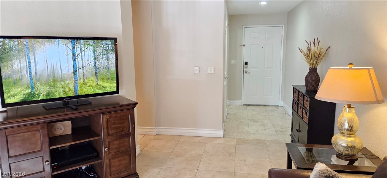 210 East Flamingo Road, Unit 208 Las Vegas, NV 89169 - Photo 11 of 42 A welcoming entryway with natural tile flooring transitions into a cozy living space.