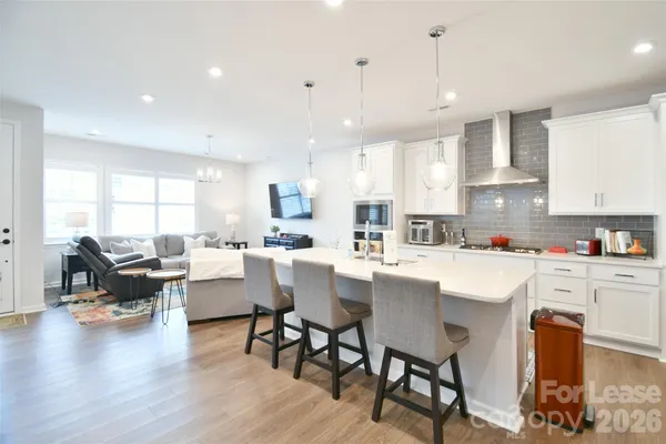 a large kitchen with a table and chairs