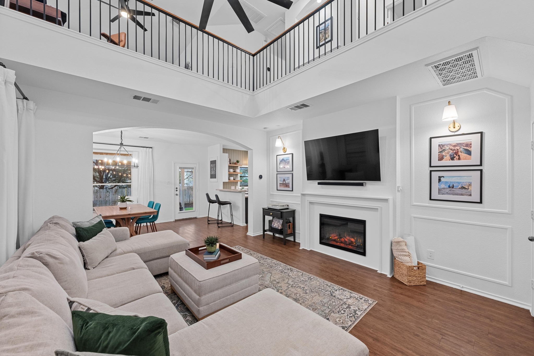 8614 Brock Circle Austin, TX 78745 - Photo 1 of 1 Living area with arched walkways, visible vents, and wood finished floors