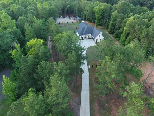 a kitchen with stainless steel appliances a table chairs refrigerator and microwave