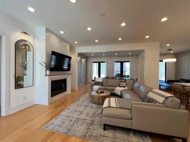a view of a a dining room with furniture and wooden floor