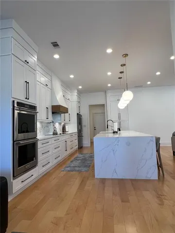 a bedroom with a bed and chandelier