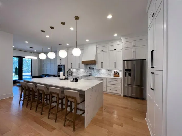 a spacious bathroom with a sink double vanity granite and a mirror
