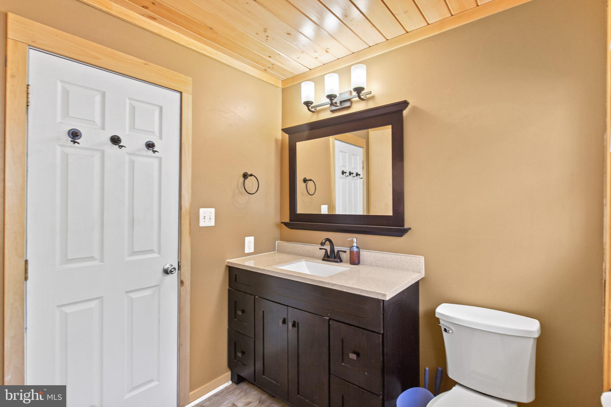 12646 High Sierra Road Lusby, MD 20657 - Photo 12 of 36 a bathroom with a toilet sink and mirror
