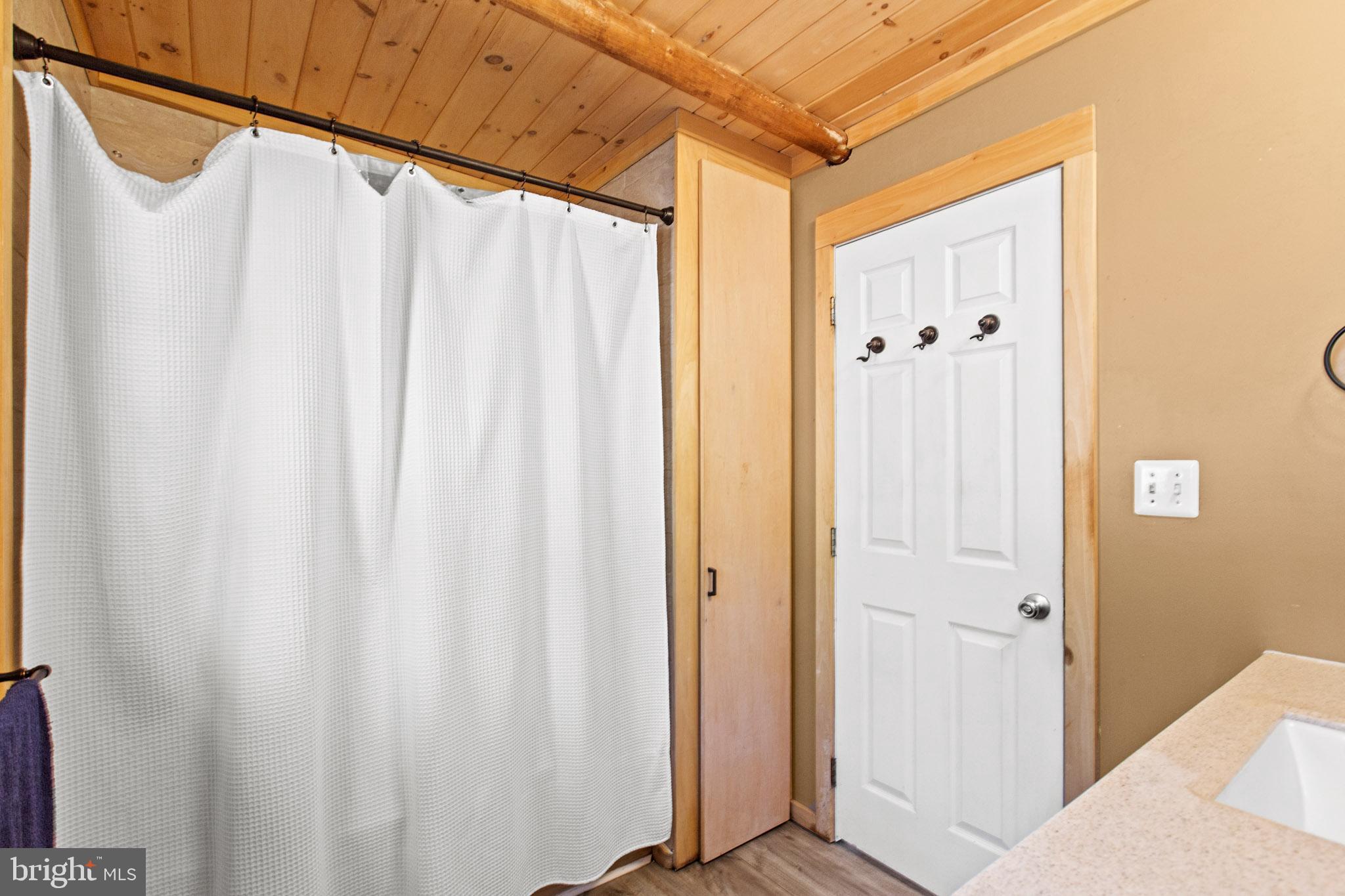 12646 High Sierra Road Lusby, MD 20657 - Photo 13 of 36 a bathroom with a shower and a curtain