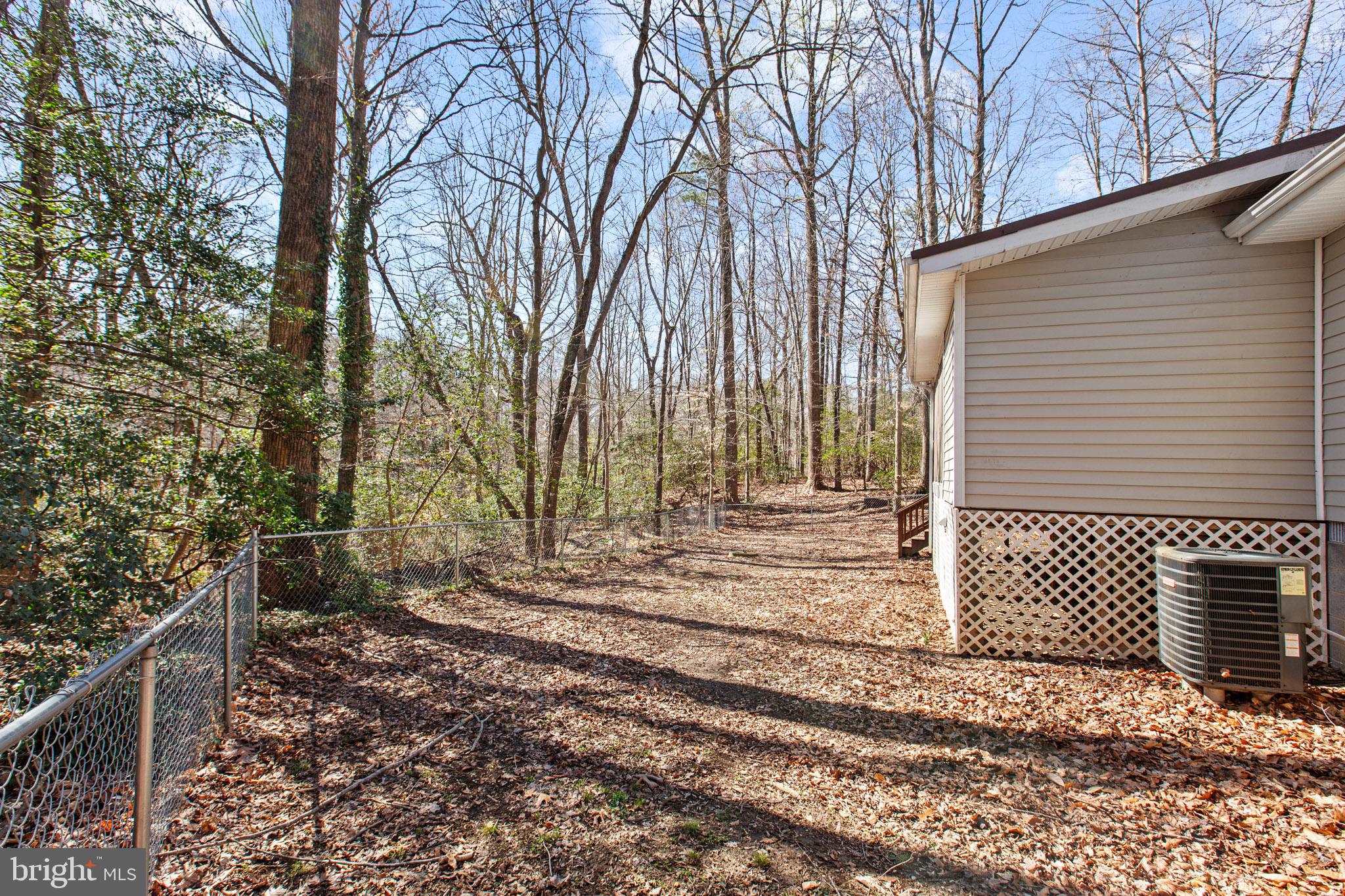 12646 High Sierra Road Lusby, MD 20657 - Photo 17 of 36 a view of a house with a yard