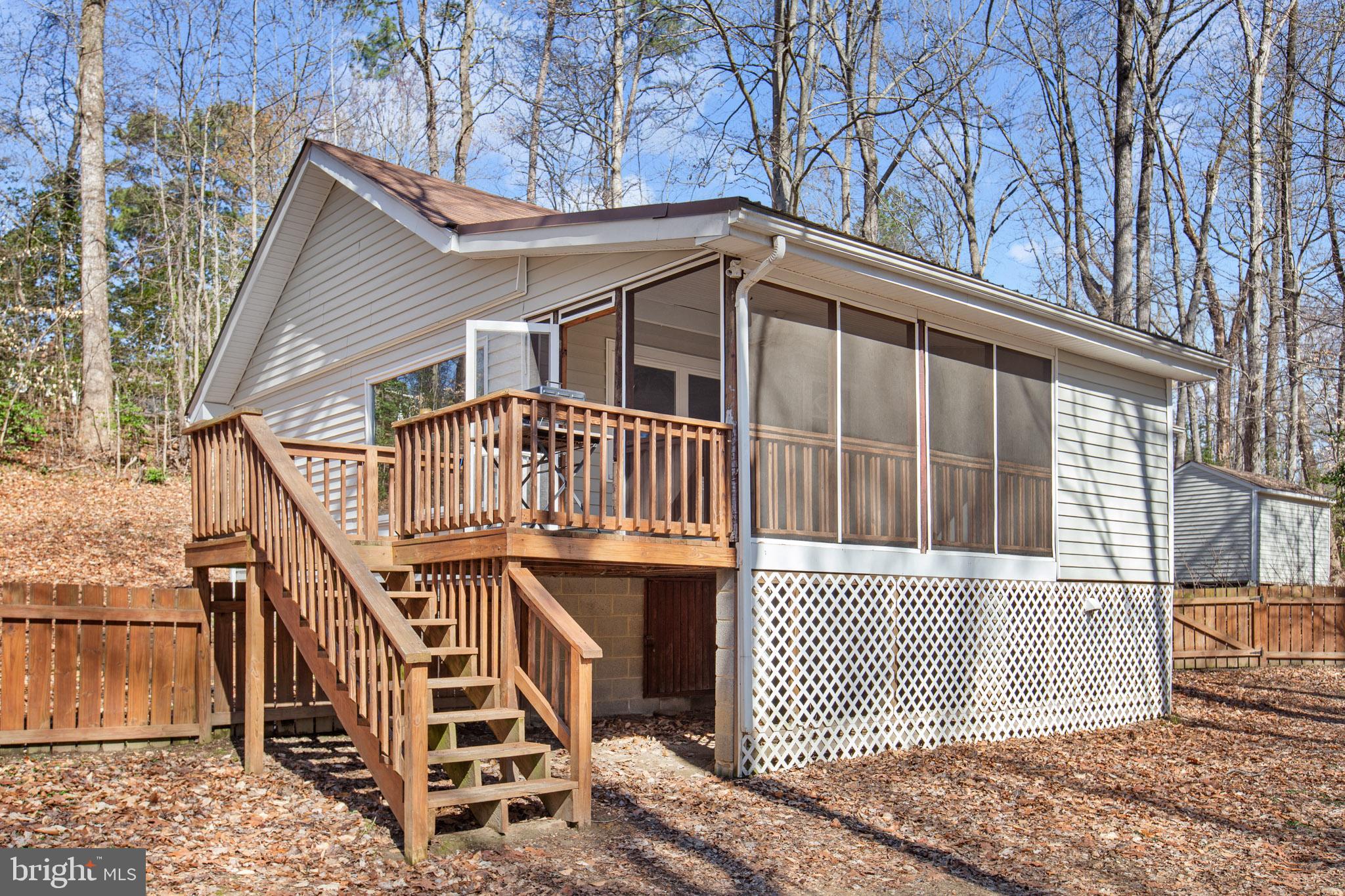 12646 High Sierra Road Lusby, MD 20657 - Photo 25 of 36 a view of a house with wooden deck front of house