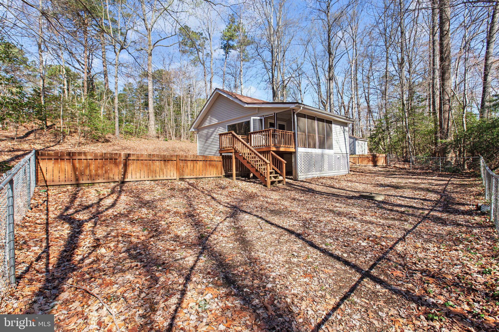 12646 High Sierra Road Lusby, MD 20657 - Photo 26 of 36 a house with trees in the background