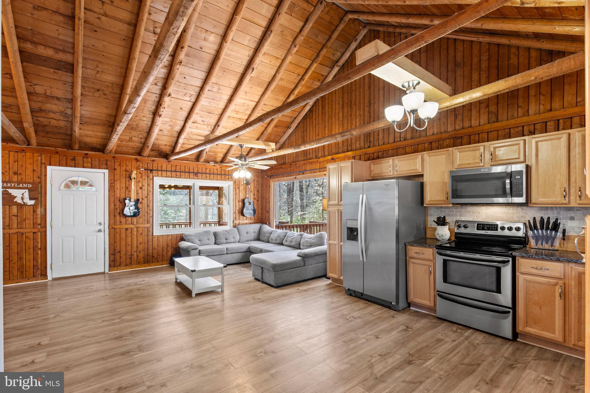 12646 High Sierra Road Lusby, MD 20657 - Photo 3 of 36 a kitchen with stainless steel appliances granite countertop a refrigerator and wooden cabinets