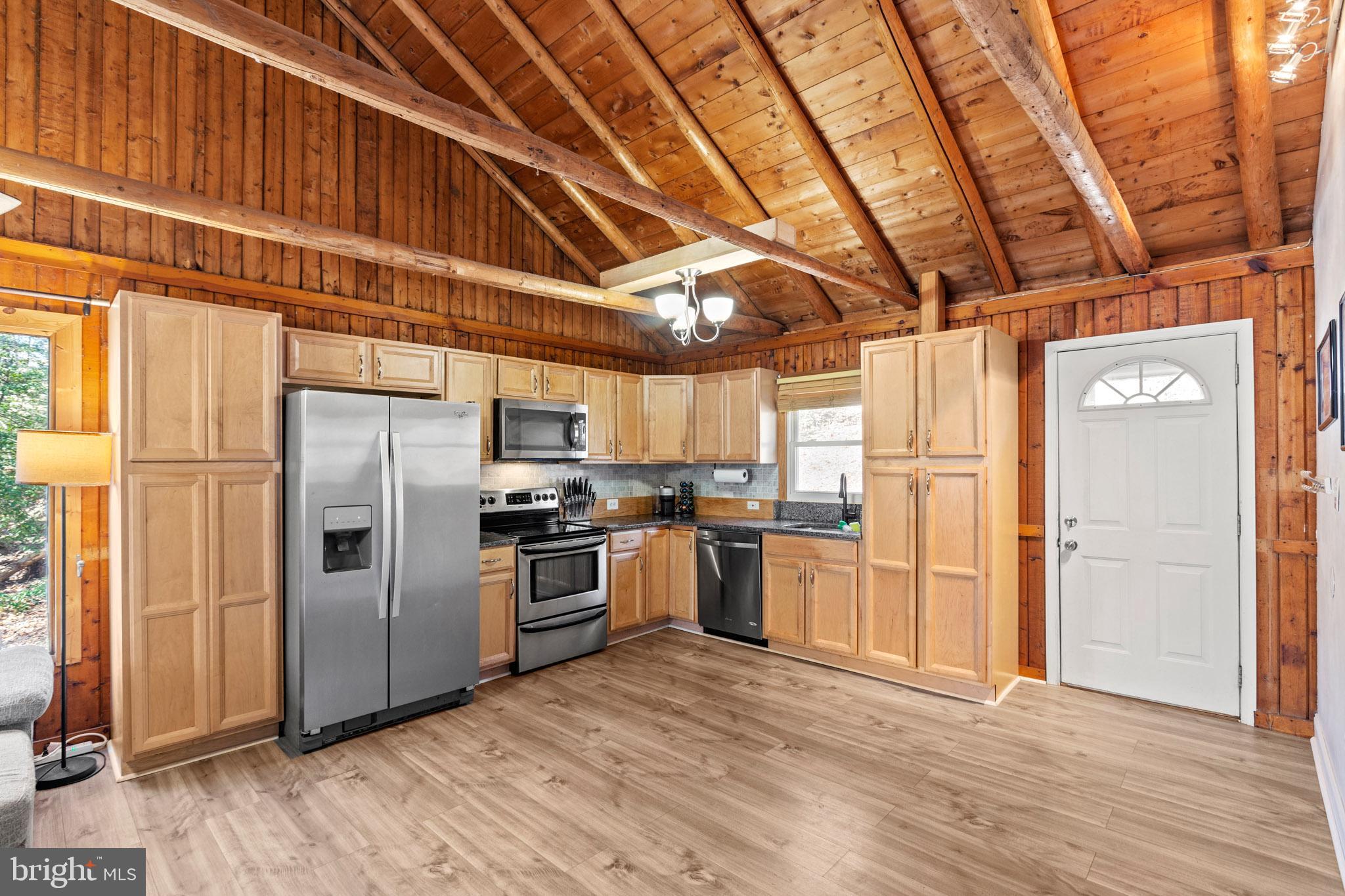12646 High Sierra Road Lusby, MD 20657 - Photo 4 of 36 a kitchen with stainless steel appliances granite countertop a refrigerator and a stove