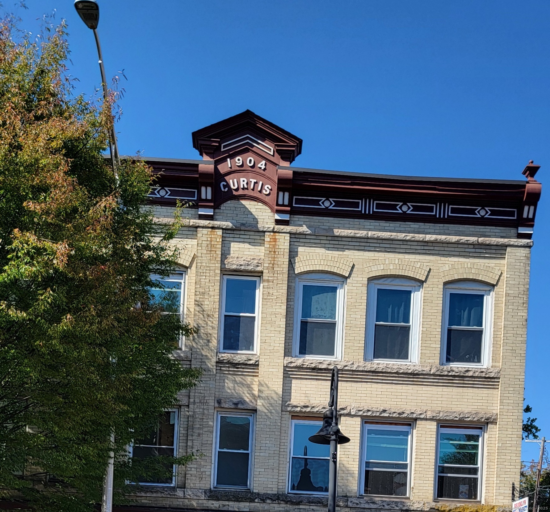 a front view of a house with plants