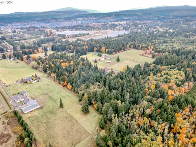 an aerial view of a house with backyard space and lake view