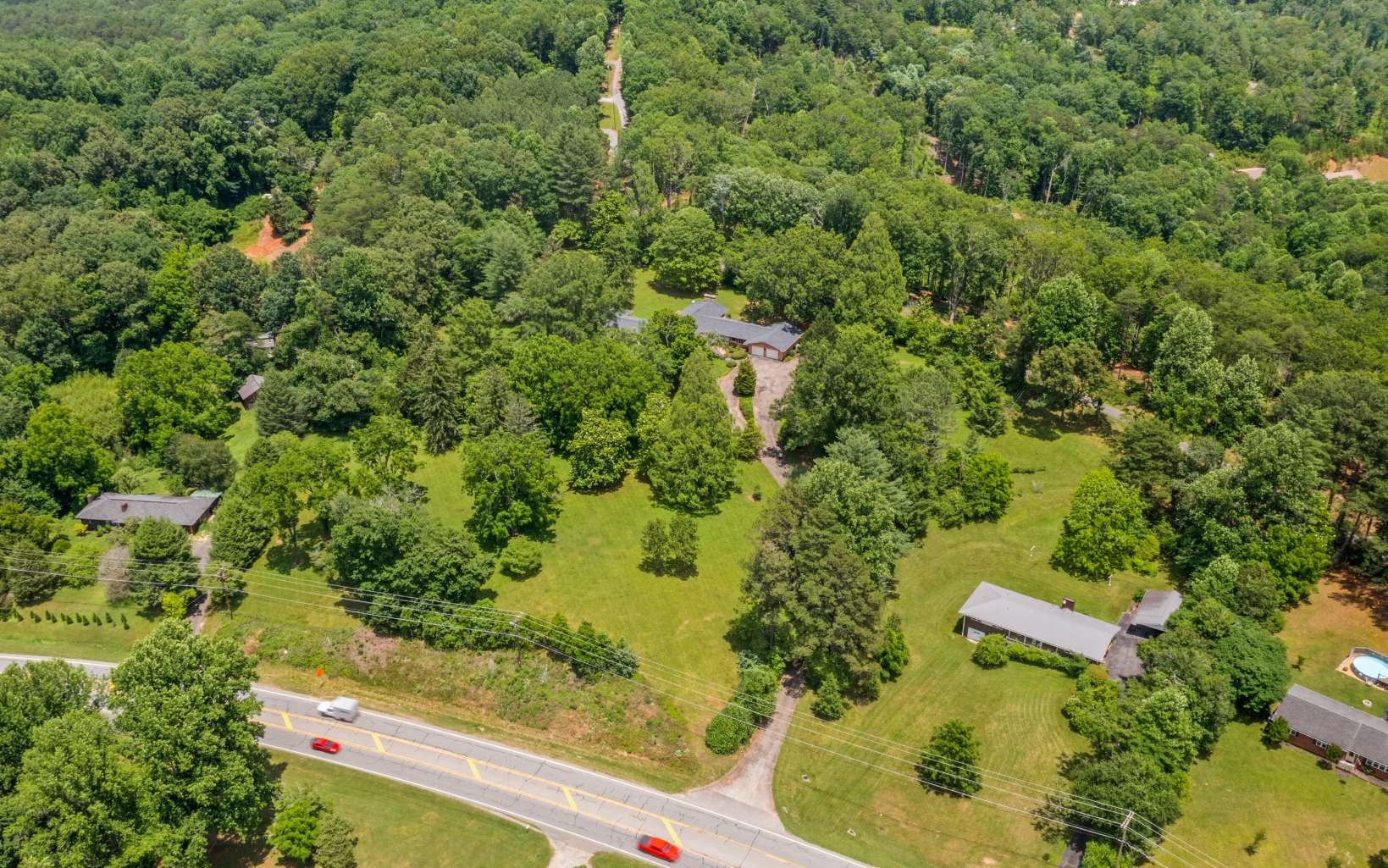 4295 Blue Ridge Drive Blue Ridge, GA 30513 - Photo 50 of 58 an aerial view of a residential houses with outdoor space and trees all around