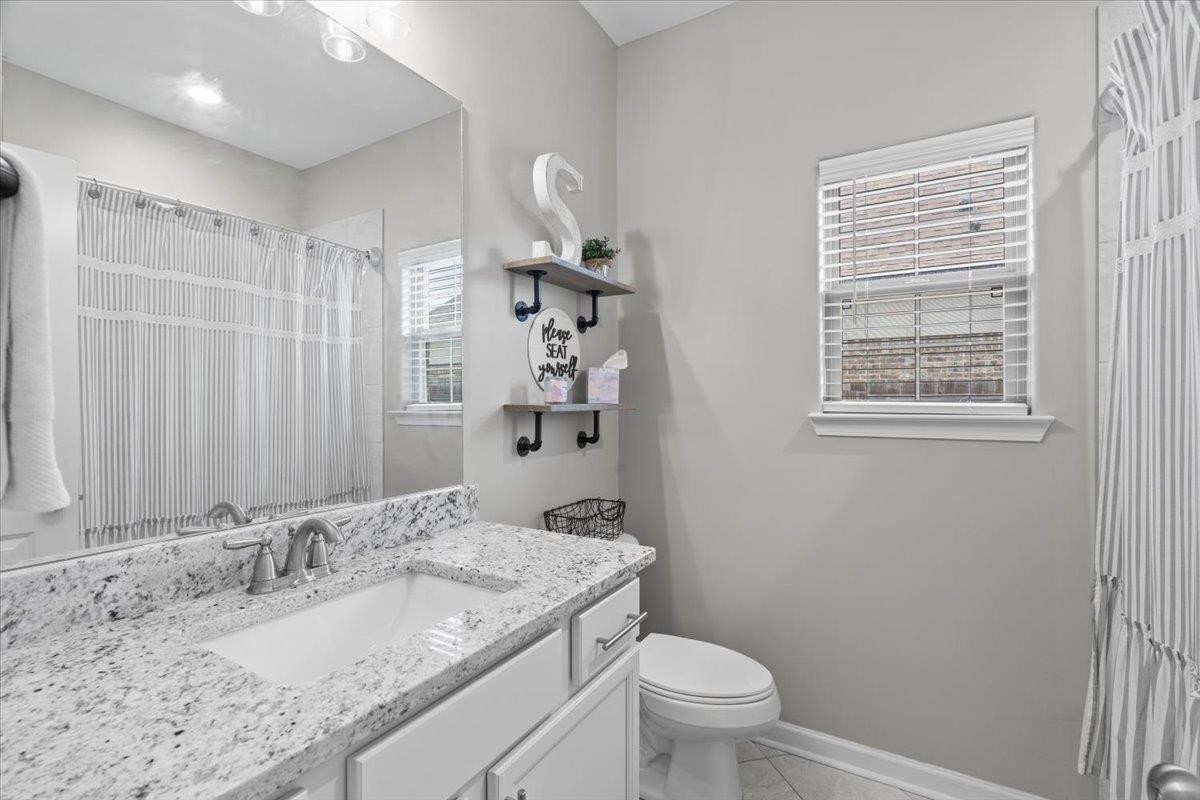 270 Whispering Ridge Drive Oakland, TN 38060 - Photo 17 of 27 a bathroom with a granite countertop sink toilet and shower