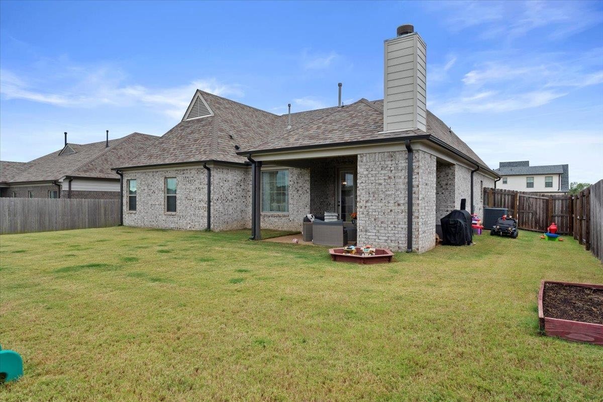 270 Whispering Ridge Drive Oakland, TN 38060 - Photo 24 of 27 a front view of a house with a garden and yard