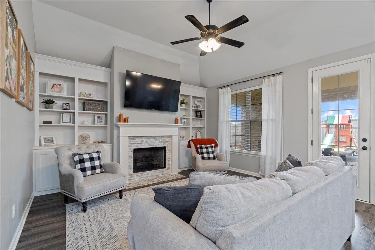 270 Whispering Ridge Drive Oakland, TN 38060 - Photo 5 of 27 a living room with furniture a flat screen tv and a fireplace